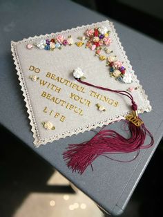 a graduation cap with flowers on it that says do beautiful things with your beautiful life