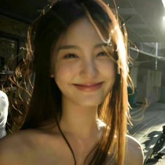 a woman with long hair smiling at the camera