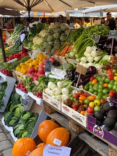 an open air market filled with lots of fresh fruits and veggies on display