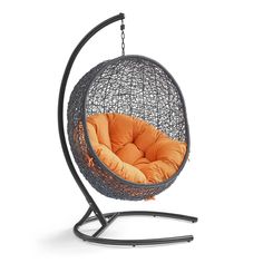 a swing chair with an orange cushion on it's back end and black stand