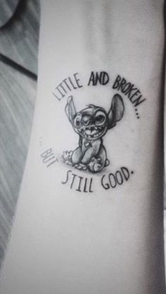 a tattoo on the arm of a person with an image of stitch and brown is still good