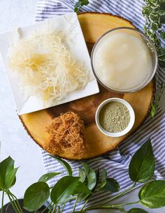 the ingredients to make this dish are displayed on a wooden platter with green leaves