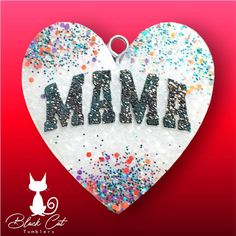 a white heart shaped ornament with the word mama on it