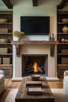 a living room with a fire place and bookshelves in front of the fireplace