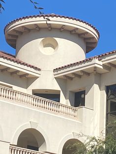 a large white building with a clock on it's face and balconies