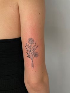 a woman's arm with a flower tattoo on the left side of her arm