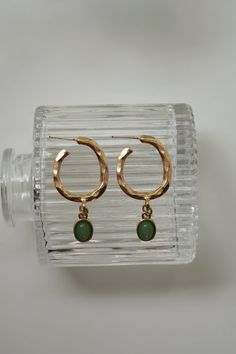 Our Dusk of Hope Earrings have a one of a kind twisted hoop that connects to a green pendant. These earrings are super light weight and dainty! Color - Green & Gold Material - Stainless Steel Measurements - 1.75 Inches Long Everyday Green Circular Earrings, Green Teardrop Metal Earrings, Green Pierced Everyday Earrings, Green Metal Clip-on Earrings For Gift, Green Pierced Earrings For Everyday, Elegant Small Hoop Green Earrings, Green Metal Dangle Earrings, Green Metal Hoop Earrings As A Gift, Green Metal Drop Clip-on Earrings