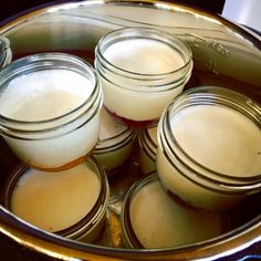 several jars filled with liquid sitting in a pot