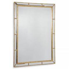 a gold framed mirror on a white wall