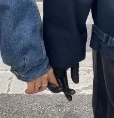 two people holding hands while standing next to each other