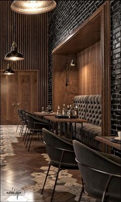 the interior of a restaurant with wooden walls and black leather chairs, brick wall, and wood paneling