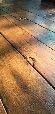 the wood floor is shiny and brown with little scratches on it's edges,