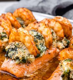 salmon with spinach and cheese served on a white platter, ready to be eaten