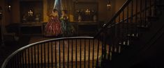 two women in evening gowns walking down the stairs to their wedding reception at night