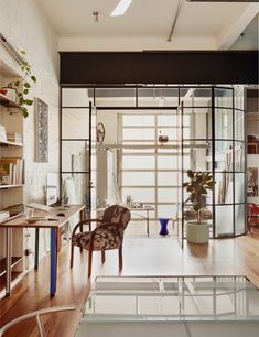 a living room filled with furniture next to a wooden floor