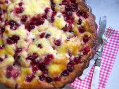 a close up of a pie on a plate with a fork and knife next to it