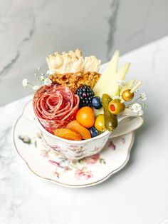 a bowl filled with different types of food on top of a saucer next to a plate