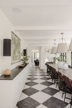 a large dining room with black and white checkered flooring