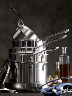 pots and pans are stacked on top of each other with utensils in them