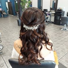 the back of a woman's head in a hair salon wearing a tiara