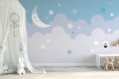 a child's room with stars and clouds painted on the wall