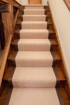 a set of stairs with carpet on the bottom, and beige carpet on the bottom