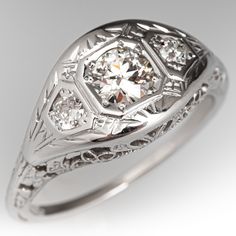 an antique style diamond ring with filigrees