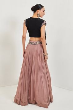 Dusky pink lehenga with pleated pattern and embroidered waistband. Comes with black draped blouse.
Components:2
Embroidered
Neckline:V-Neck
Sleeve Length:Cap
Fabric:Raw Silk, Georgette, Crepe
Color:Black, Pink
Pearl embroidery
Embroidered blouse with drape at one side - Aza Fashions Raw Silk Embroidery, Silk Pleated Skirt, Lehenga Pattern, Pleated Pattern, Skirt Draping, Pearl Embroidery, Draped Blouse, Pink Lehenga, Black Drapes