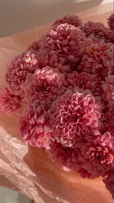 a bunch of pink flowers sitting on top of a table