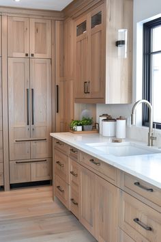 a kitchen with wooden cabinets and white counter tops