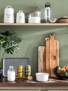 the kitchen counter is full of ingredients and utensils, including eggs, milk, oranges, and other items