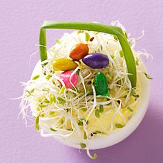 an easter egg filled with candy and sprouts