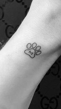 a dog paw with a heart tattoo on the wrist