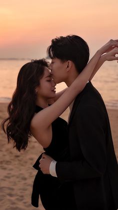 a man and woman are kissing on the beach