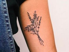 a woman's arm with a flower tattoo on the back of her left arm