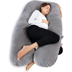 a pregnant woman is sleeping on an inflatable pillow with her arms behind her head