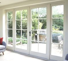 a living room with two couches and french doors leading to the outside patio area