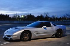 a silver sports car parked in a parking lot