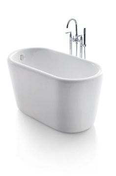 a white bath tub sitting next to a faucet