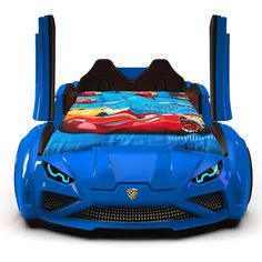 a blue toy car bed sitting on top of a white floor