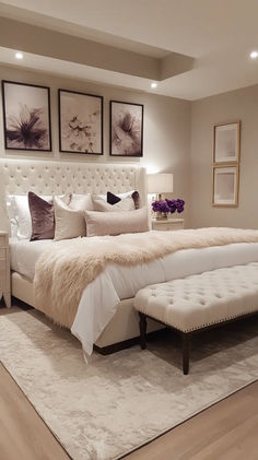 a large white bed sitting on top of a wooden floor