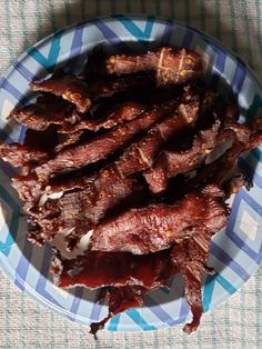 a blue and white plate topped with beef strips