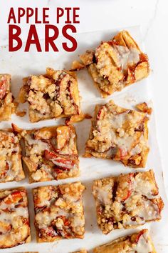 apple pie bars are lined up on a sheet of parchment paper