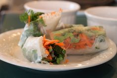 two rolls with carrots and lettuce on a plate