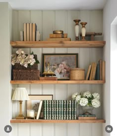 shelves with books, vases and pictures on them