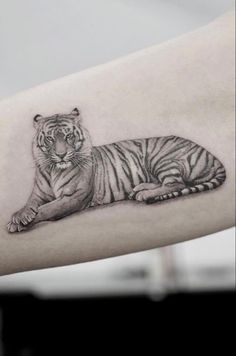 a white tiger tattoo on the arm