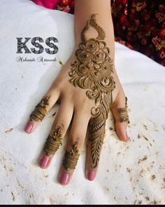 a woman's hand with henna tattoos on it