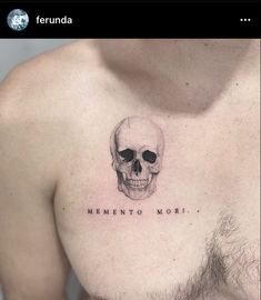 a man's chest with a skull tattoo that says, mementoo moi