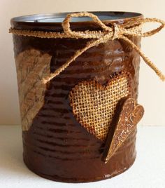 a brown tin can with a heart on it and some twine around the top