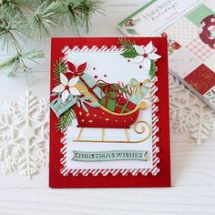 a christmas card with a sleigh on it and snowflakes in the background